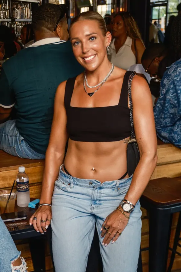 Guest in a black top seated beside the bar