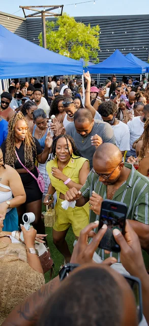 The Chapman Sundays crowd dancing under the blue tents